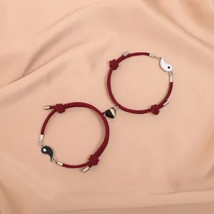 Magnetic couple bracelets set with matching red rope and black white yin yang heart charm.