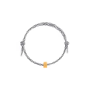 Detail view of a stylish black and white woven rope bracelet with metallic gold and silver accents.