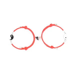 Couple red rope bracelets with magnetic heart and tai chi pendants, product detail view.