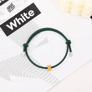 Green rope escape bracelet with metal ends and golden bead for men and women daily wear.