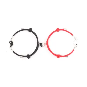 Detail shot of magnetic couple bracelets with Tai Chi charms and black red Milan ropes.