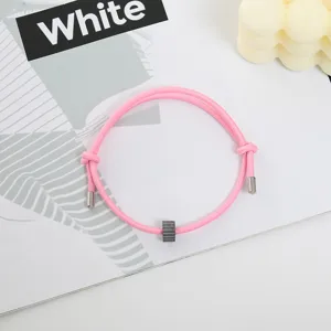 Pink woven cord bracelet with tungsten carbide bead and metal tips, detailed view showcasing style.