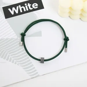 Dark green paracord bracelet with tungsten carbide bead and metal tips for daily wear and escape.