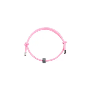 Pink rope survival bracelet with dark bead and metal tips for men and women daily wear.