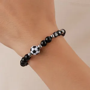 Detail shot of the 8mm black beaded bracelet featuring a soccer charm and letter A bead on wrist.