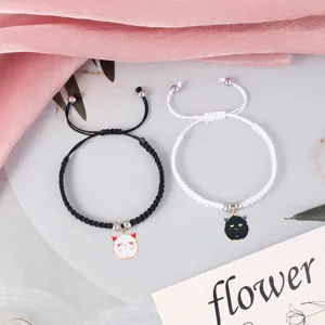 Handmade braided couple bracelets with cute devil pendants, matching black and white set.