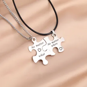 Stainless steel puzzle couple necklace detailed shot showing engraved matching pendant design.
