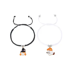 Halloween woven couple bracelets detail featuring witch and ghost charms in black and white.