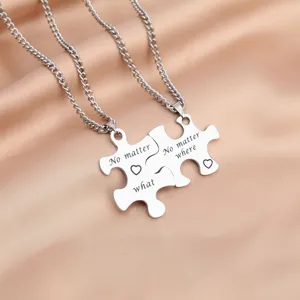Stainless steel couple puzzle necklace set featuring engraved love pendant details.