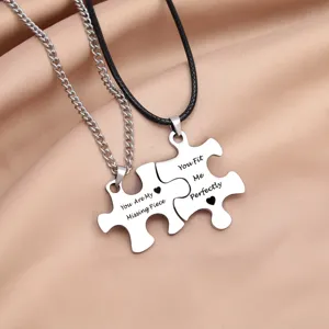 Couple puzzle necklace detail view, stainless steel engraved pendants for lovers, romantic jewelry.