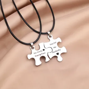 Stainless steel couple puzzle necklace detail view showing engraved romantic love messages.