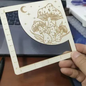 Holz Pilz Maschenprobe Messschieber Detailansicht mit laser graviertem Motiv und Zentimeterskala.