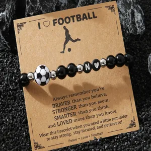 Details of football beaded bracelet with black shiny beads and letter N charm on card.
