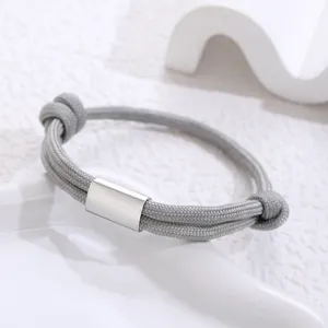 Detailed view of a grey paracord woven bracelet with a sleek silver stainless steel metal tube.