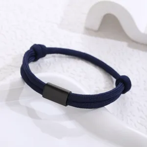 Close-up of the dark blue braided paracord bracelet with a sleek black stainless steel tube.