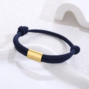 Minimalist dark blue paracord bracelet with a sleek gold stainless steel tube centerpiece.