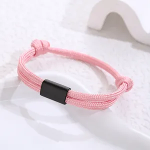 Handmade woven pink paracord bracelet featuring a black stainless steel tube detail view.