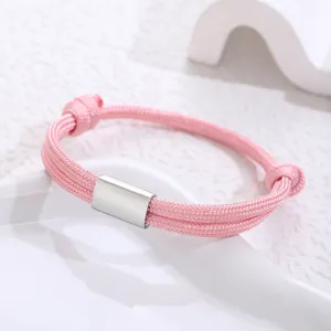 Close-up of a handmade pink paracord stainless steel bracelet, minimalist design detail.