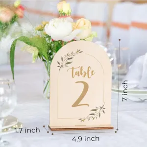 Wooden arched table number sign detail view with floral decor and clear size marks for wedding.