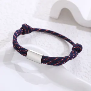 Handcrafted paracord bracelet with stainless steel tube, blue and red woven rope design for daily wear.