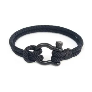 Détail du bracelet en cordon tressé noir avec boucle de fer à cheval en acier inoxydable.