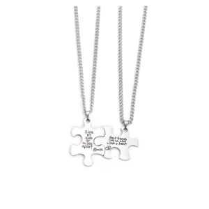 Stainless steel puzzle matching friendship necklace detail close-up, silver tone metal jewelry