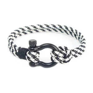 Détail de corde tressée noire et blanche avec boucle de manille en acier inoxydable bracelet