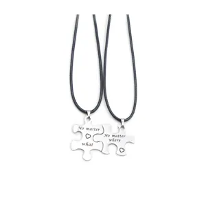 Stainless steel puzzle couple necklace detail shot with romantic engraved text quotes.