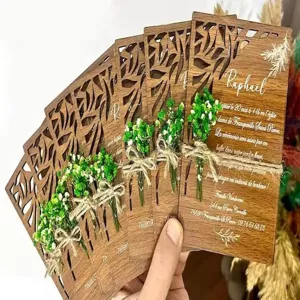 Wooden laser cut wedding invitation card with preserved flowers and custom engraved text details.