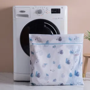Printed mesh laundry bag with blue leaf pattern and zipper for delicate clothes washing.