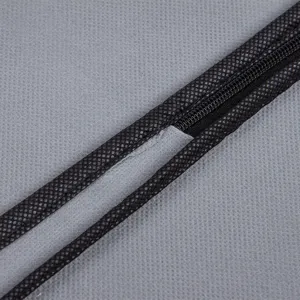 Grey non-woven breathable garment dust cover with durable zipper for coat storage.