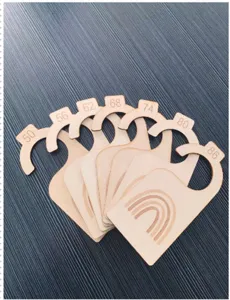 Wooden baby closet dividers with cute rainbow design, perfect nursery organization.