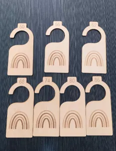 Wooden baby closet dividers with cute rainbow engraving and clear size numbers for nursery organization.