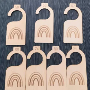 Wooden baby closet dividers with rainbow pattern and size tags for newborn nursery organization.