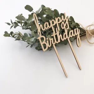 Wooden happy birthday cake topper detail, natural eucalyptus leaf background decor photo prop.