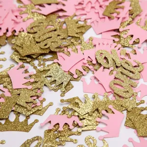 Detailopname die roze en gouden glitter kroonconfetti toont voor het kinderfeest.