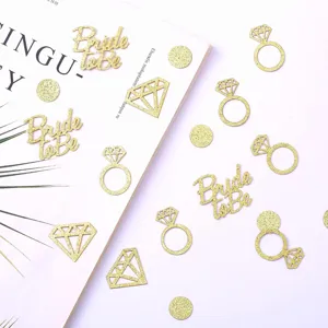 Gold glitter bride to be diamond ring confetti for wedding party table decoration setup.