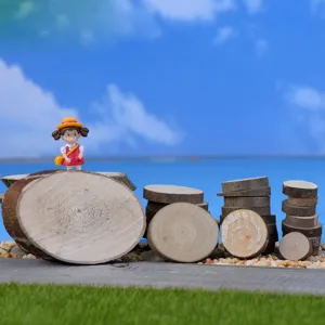 Miniature wood slices set with cute character figurine for micro landscape decor and crafts.