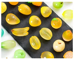 Dettaglio ciondoli in resina di frutta, design sfumato ad alta trasparenza per artigianato fai da te.