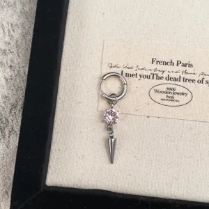 Close-up of pink rhinestone cone pendant drop earring detail, delicate metallic charm.