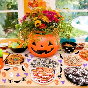 Halloween party confetti decoration details showing ghost, pumpkin and spider shapes for spooky table decor