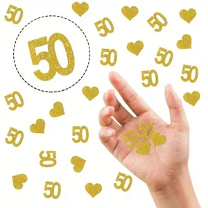 Gold glitter 50 number confetti and hearts for 50th birthday and anniversary party decorations.