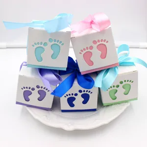 European hollow baby favor candy boxes with cute footprints and colorful ribbons for parties.