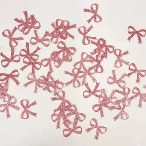 Roze glitter strik confetti decoraties, perfect voor verjaardagsfeestjes en knutselen.