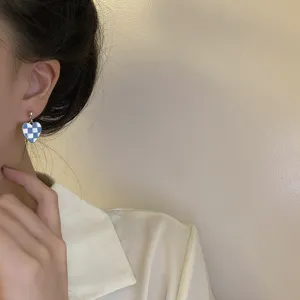Blue and white checkered heart earring detail shot, exquisite minimal design