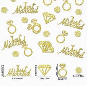 Detail view of gold glitter wedding confetti featuring Just Married text, rings, and diamonds.