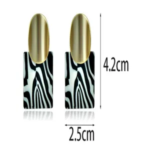 Chic matte gold and black zebra acrylic drop earrings with stylish geometric design.