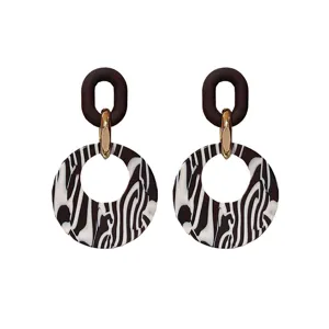 Trendy geometric acrylic dangle earrings featuring stylish black and white abstract pattern.