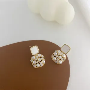 Close-up detail shot of vintage square pearl crystal earrings featuring elegant design.