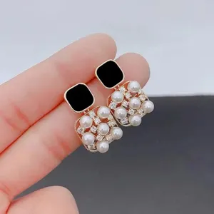 French vintage square pearl earrings with black top and sparkly rhinestones detail.